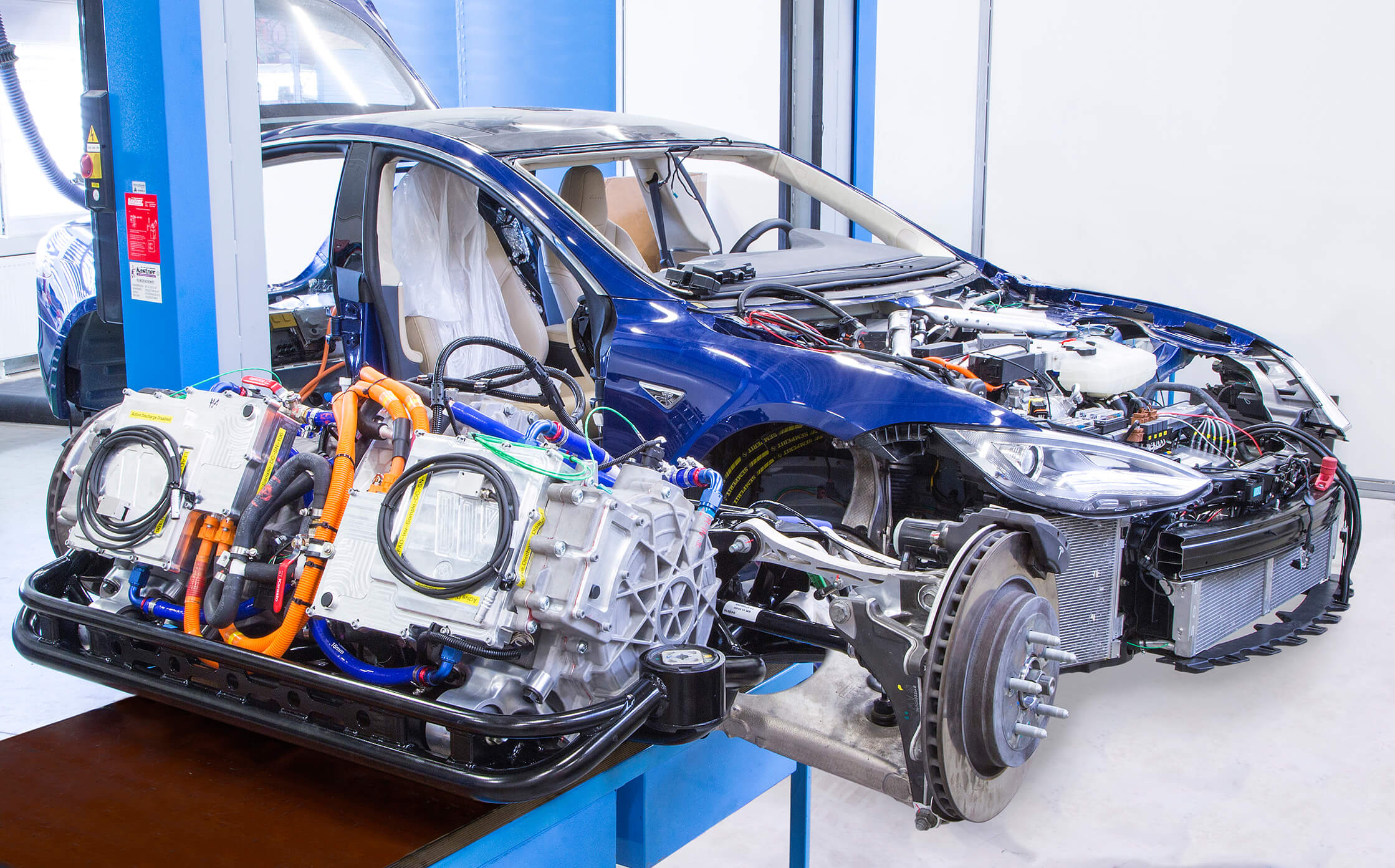 eDrive/eAxle Integration Partly disassembled battery electric vehicle with a high voltage MAGNA eAxle in the foreground.
